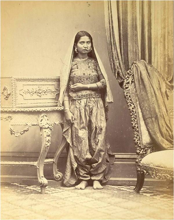 Muslim girl showing method of wearing ear and nose rings, and anklets, 1870