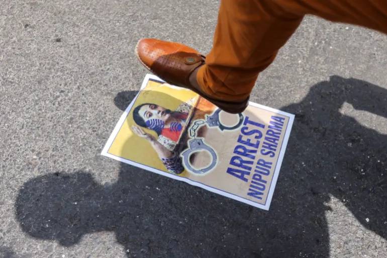 A demonstrator stomps on a poster of Sharma during a protest in Mumbai. Source: Reuters