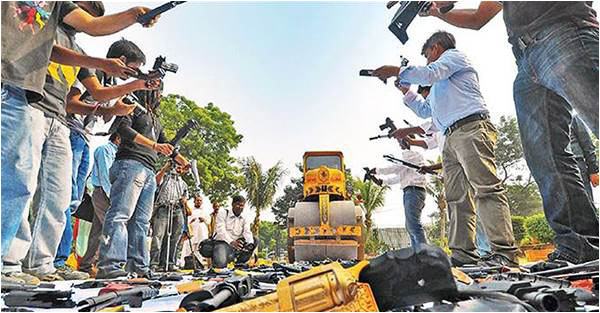 Plastic guns being bulldozed as a symbolic gesture