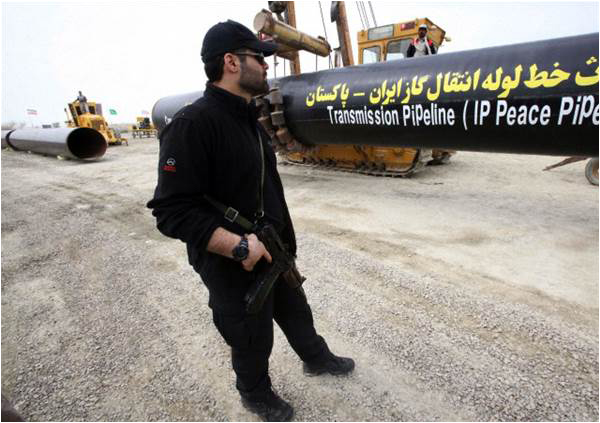 An Iranian security guard stands near the under-construction gas pipeline in Chabahar area of southeastern Iran