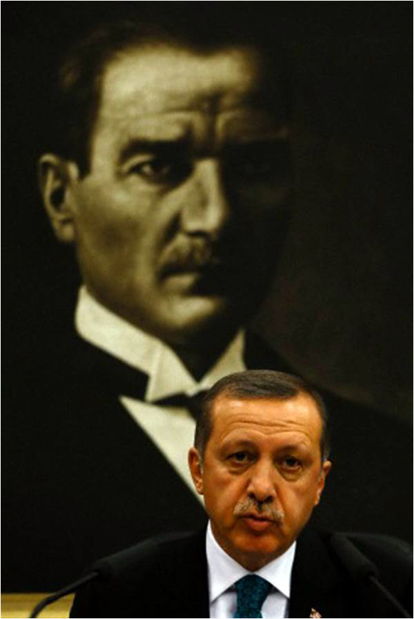 Erdogan addresses the media as he sits in front of a portrait of Mustafa Kemal Ataturk, at the height of his row with Gulen