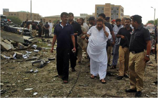 A picture dated 19 September 2011 shows Chaudhry Aslam inspecting the scene of a suicide car bomb attack targeting his house