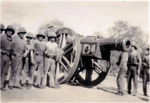 British Troops posing in front of Kim's Gun in 1930s passing through Lahore on the way to North West Frontier Province