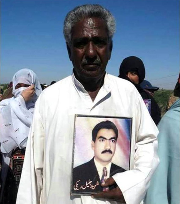 Mama Qadeer holding his dead son's photo