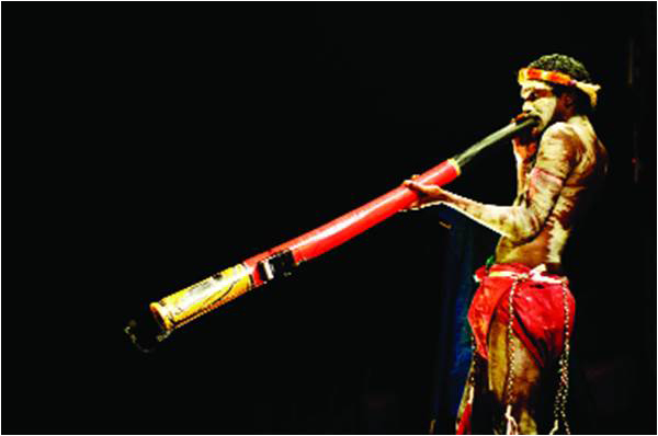 Native Australian man playing the Digeridoo