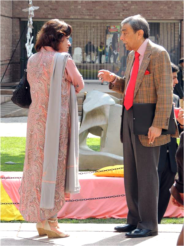 Zia Mohiyuddin talks to a lady as he waits for his session to begin
