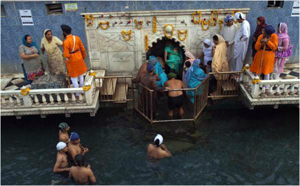 Visiting Sikh pilgrims wait for their turn to visit a holy place in Hasan Abdal, during a religious festival in 2012