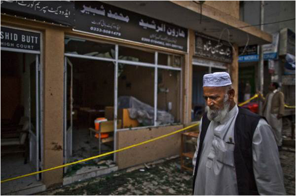 An elderly man stands at the site of Monday's attack in Islamabad