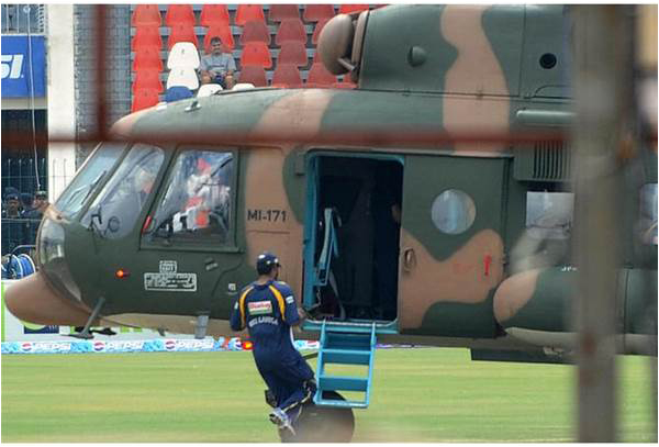 A Sri Lankan player rushes to the safety of a helicopter inside the grounds