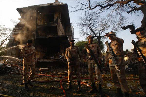 Rangers troops stand at the site of a bomb attack on their office in Karachi in 2012