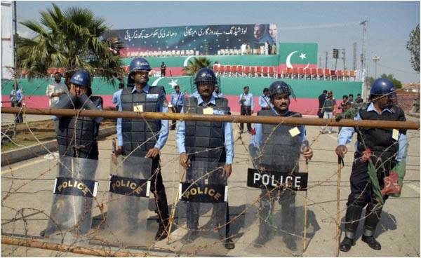 Policemen stand alert at the site of the PTI rally