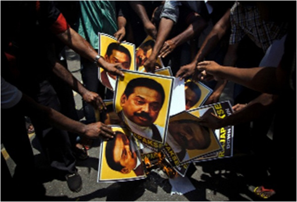 Supporters of India's MDMK party burn portraits of Sri Lankan President Mahinda Rajapaksa during a protest in New Delhi on May 26