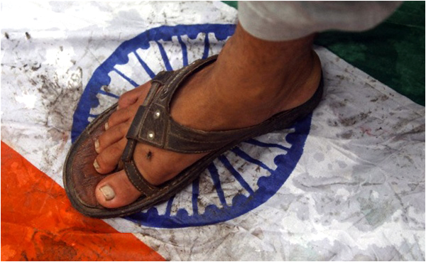 Supporters of Jamaat ud Dawa step on an Indian flag during an anti-Indian protest rally in Karachi