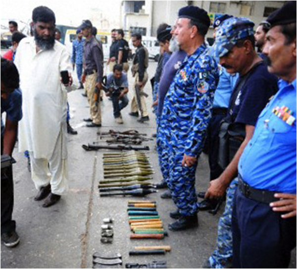 Policemen show weapons seized from the dead attackers