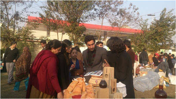 Hyder explains the work of Rt Indus to visitors at the Khalis Market in Lahore