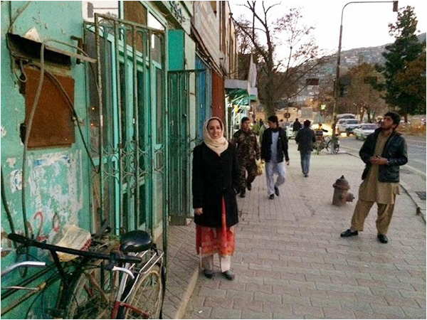 The author posing outside Shah M Book Co., the quaint but well-stocked Kabul bookshop
