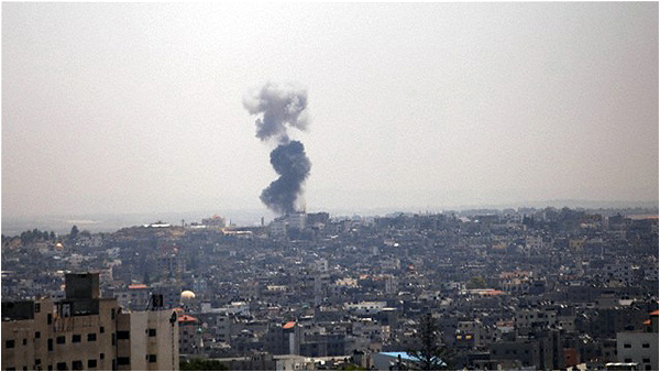 Smoke rises from a neighborhood following an Israeli air strike in Gaza City on July 8