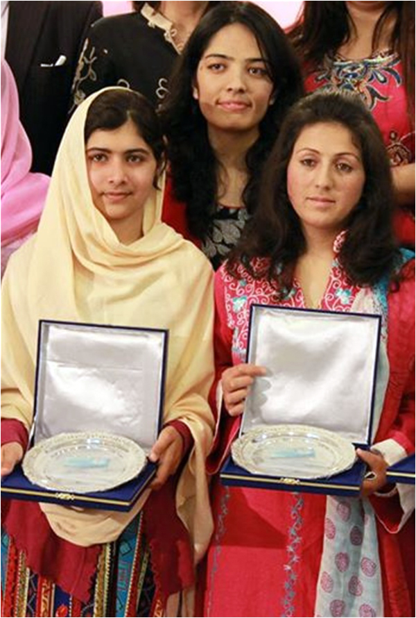 Receiving an award alongside Malala