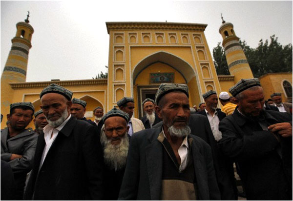 Muslim men of Uighur ethnicity leave the Id Kah mosque in Kashgar, in the Xinjiang province of China