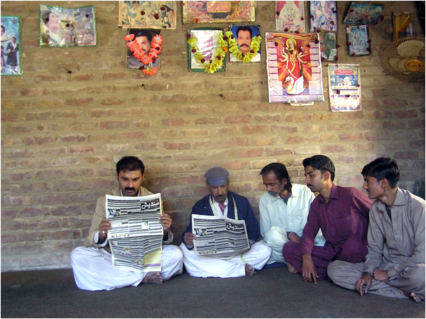 Hindu men read Sandesh