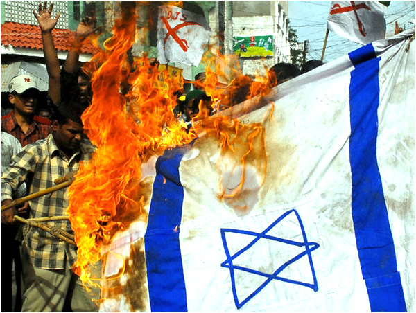 Activists from a Muslim organization burn an Israeli flag at a protest in Hyderabad, India