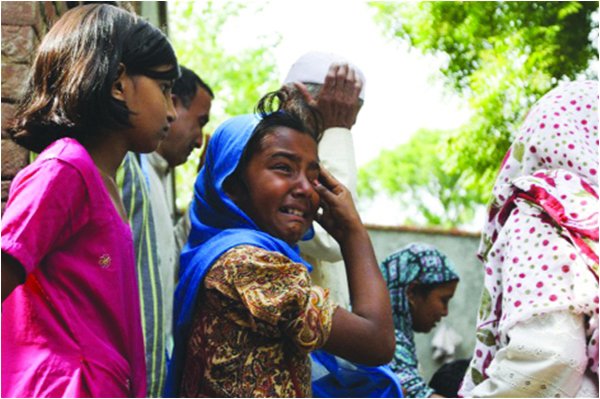Indian Muslims grieve the death of their relatives in communal violence in Muzaffarnagar