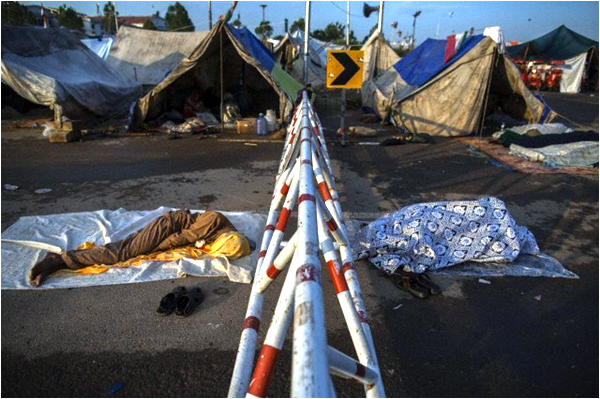 Protesters camping outside the Parliament sleep near their tents