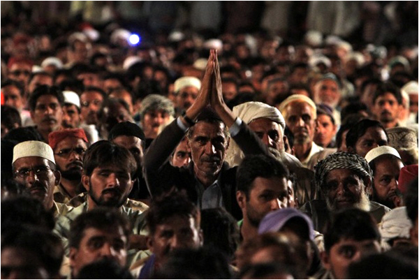 A supporter of Qadri gestures during his speech in Islamabad