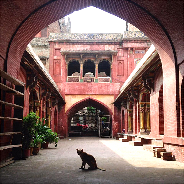 Wazir Khan Mosque – pateint subject sits motionless in the corridor outside the main mosque