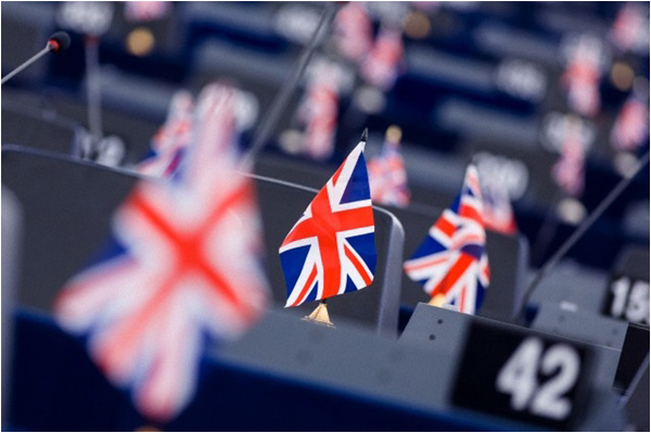 Anti-EU leaders of UKIP place UK flags on their seats in protest during a session of the European Parliament in July