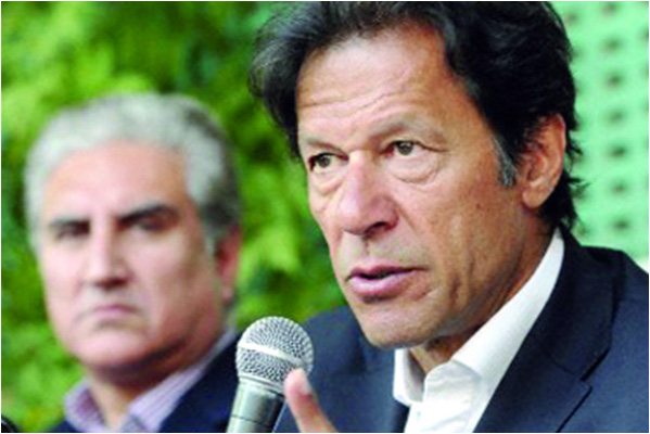 Imran Khan speaks against US drone attacks at a press conference as former foreign minister Shah Mahmood Qureshi looks on