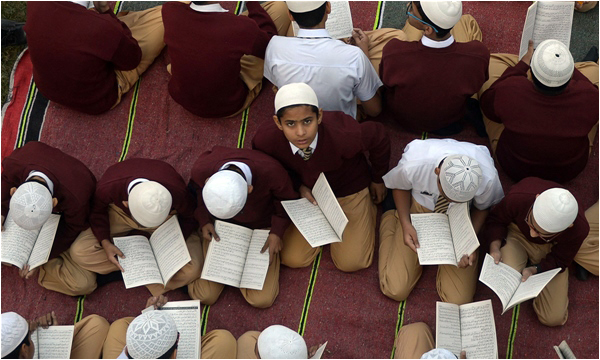 Students in Karachi read the Holy Quran and pray for the victims