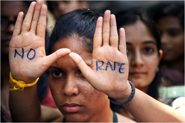 An Indian student with the words NO RAPE inscribed on her palms (Mahesh Kumar AP)