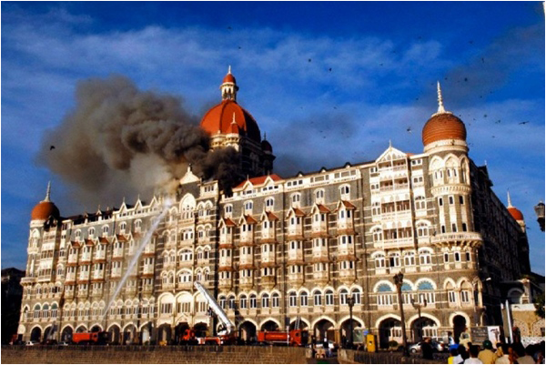 A file picture dated 27 November 2008 shows firefighters trying to douse the fire as smoke rises from the Taj hotel building in Mumbai