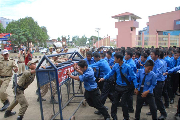 Students trying to break the barricade during a protest rally