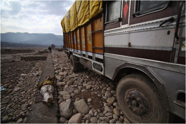 An Indian truck driver sleeps as he waits for the reopening of the Line of Control in Poonch in 2013