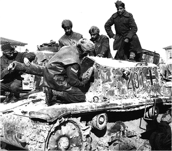 British Indian Army soldiers examine a captured German tank during World War II