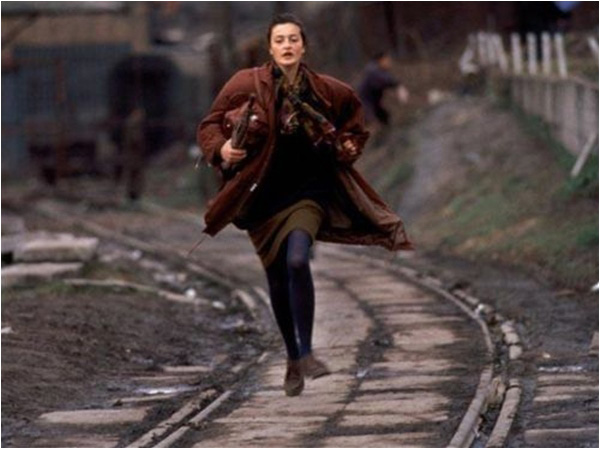 A woman runs to avoid sniper fire during the siege of Sarajevo
