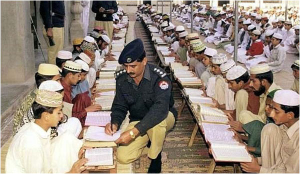 Policemen at a madrassah - the registration and regulation of these institutions has repeatedly appeared in public debate