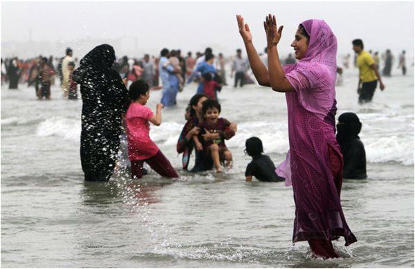 Young women beat the heat with a dip at Clifton's beaches, Karachi