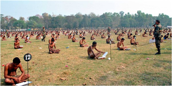 Candidates for the Indian Army appearing in the entrance examination in an open field