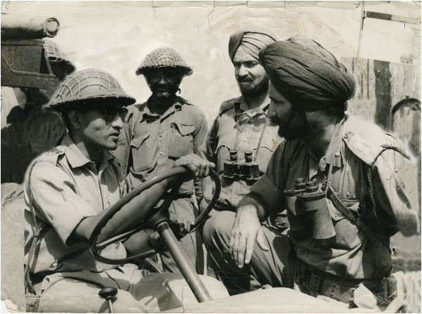 A Pakistani soldier coordinates with Indian troops in the process of recovering dead bodies, 1965