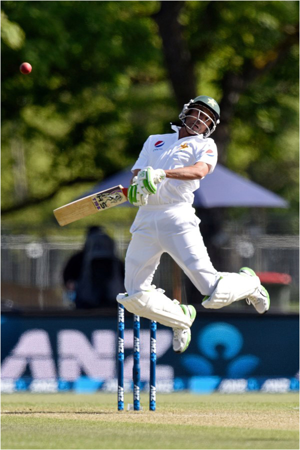 Younis Khan jumps out of the way of a bouncer