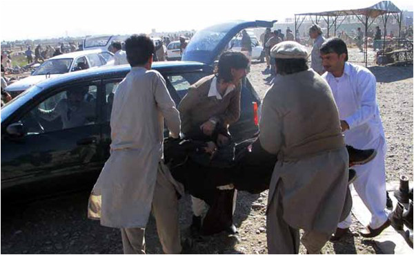 An image from December 2015, as local men carry away one of the victims of a terrorist attack in a Parachinar market