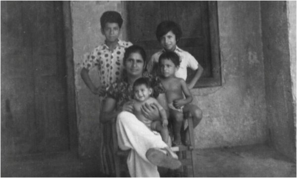The author's mother and siblings in front of the room that his family lived in, during the 1960s