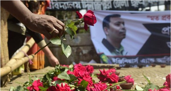 Mourners bring flowers in honour of slain blogger and secular activist Avijit Roy