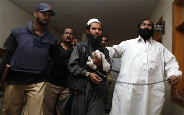 Police escort a suspected terrorist to a district court in Karachi