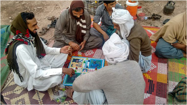 Killing time - truck drivers enjoy a game of Ludo